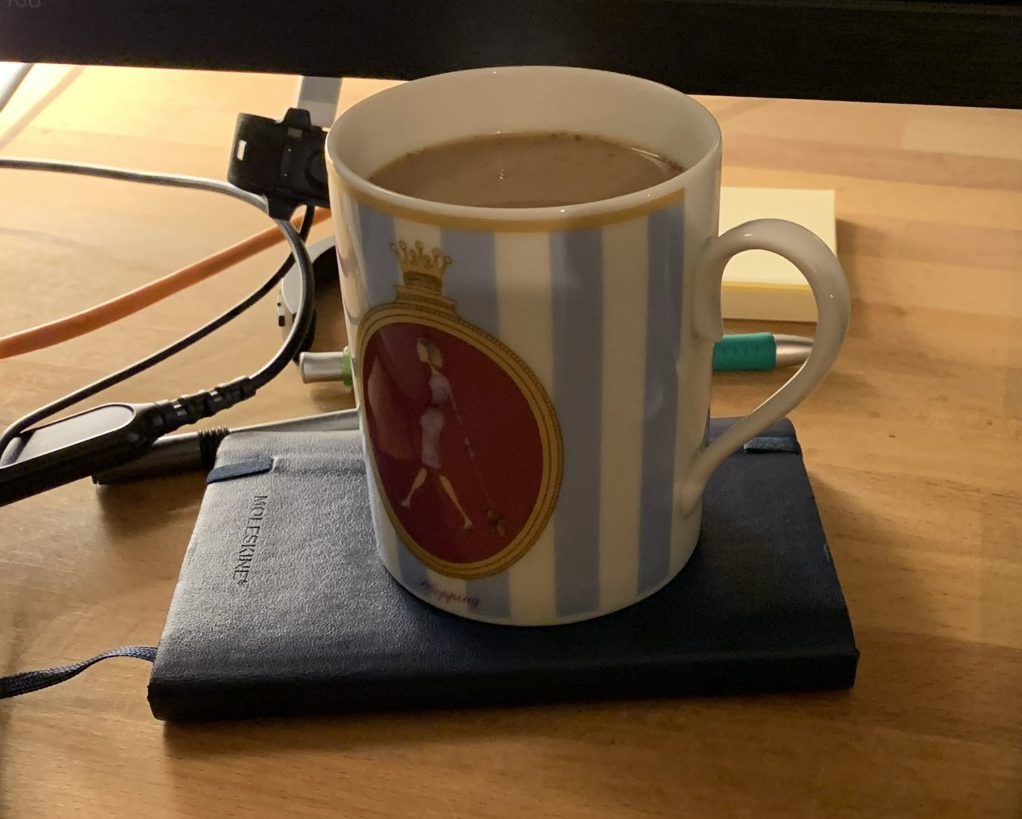 A mug using a Moleskine notebook as a coaster